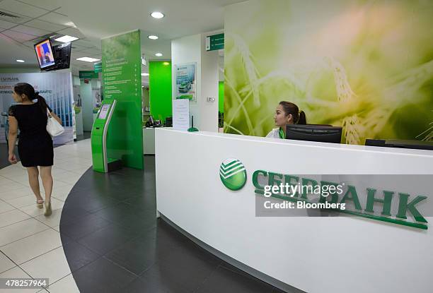 An employee works at the reception desk inside an OAO Sberbank bank branch in Almaty, Kazakhstan, on Tuesday, June 23, 2015. Kazakhstan completed its...