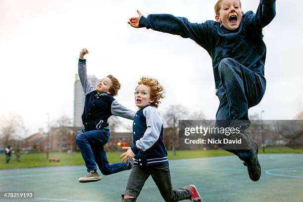 children playing in park - britain playgrounds fotografías e imágenes de stock