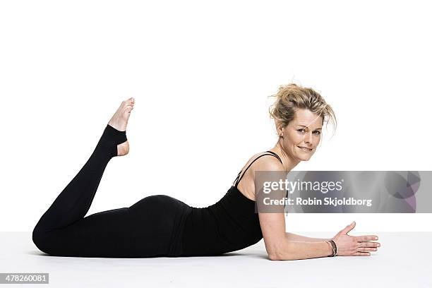 sporty woman doing yoga exercise on floor - ligga på mage bildbanksfoton och bilder