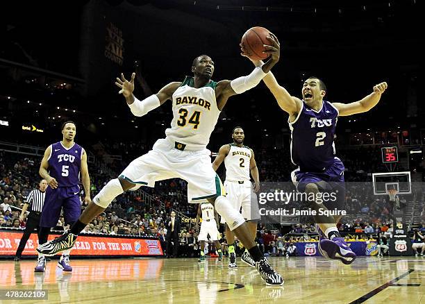 Cory Jefferson of the Baylor Bears and Michael Williams of the TCU Horned Frogs vie for a loose ball during the Big 12 Basketball Tournament first...