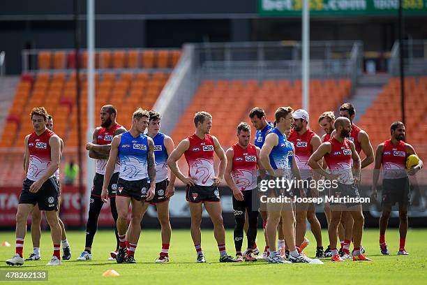 Ryan O'Keefe warms up with teammates during Sydney Swans training session ahead of the round one AFL match between the Greater Western Sydney Giants...