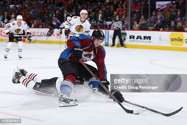 Matt Duchene of the Colorado Avalanche controls the puck against the defense of Johnny Oduya of the Chicago Blackhawks at Pepsi Center on March 12,...