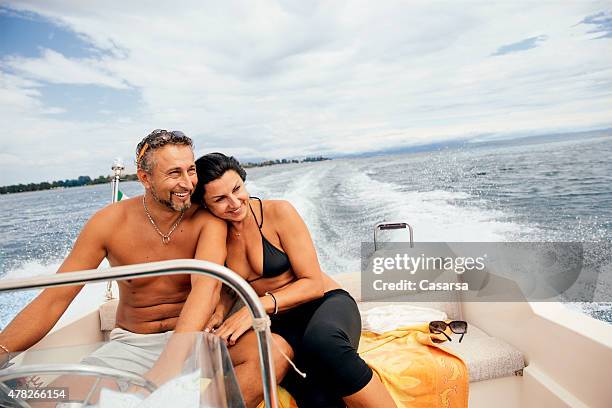 couple enjoying a ride on a speedboat - speed boat stock pictures, royalty-free photos & images