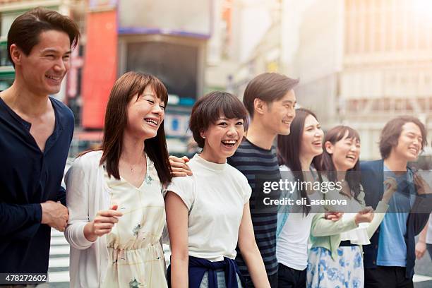 group of happy young japanese people fun outdoors, tokyo. - teenagers japanese stock pictures, royalty-free photos & images