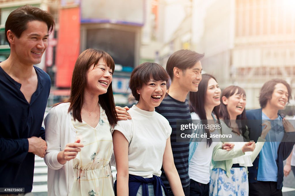 Grupo de jovens feliz se divertir ao ar livre, povo japonês em Tóquio.