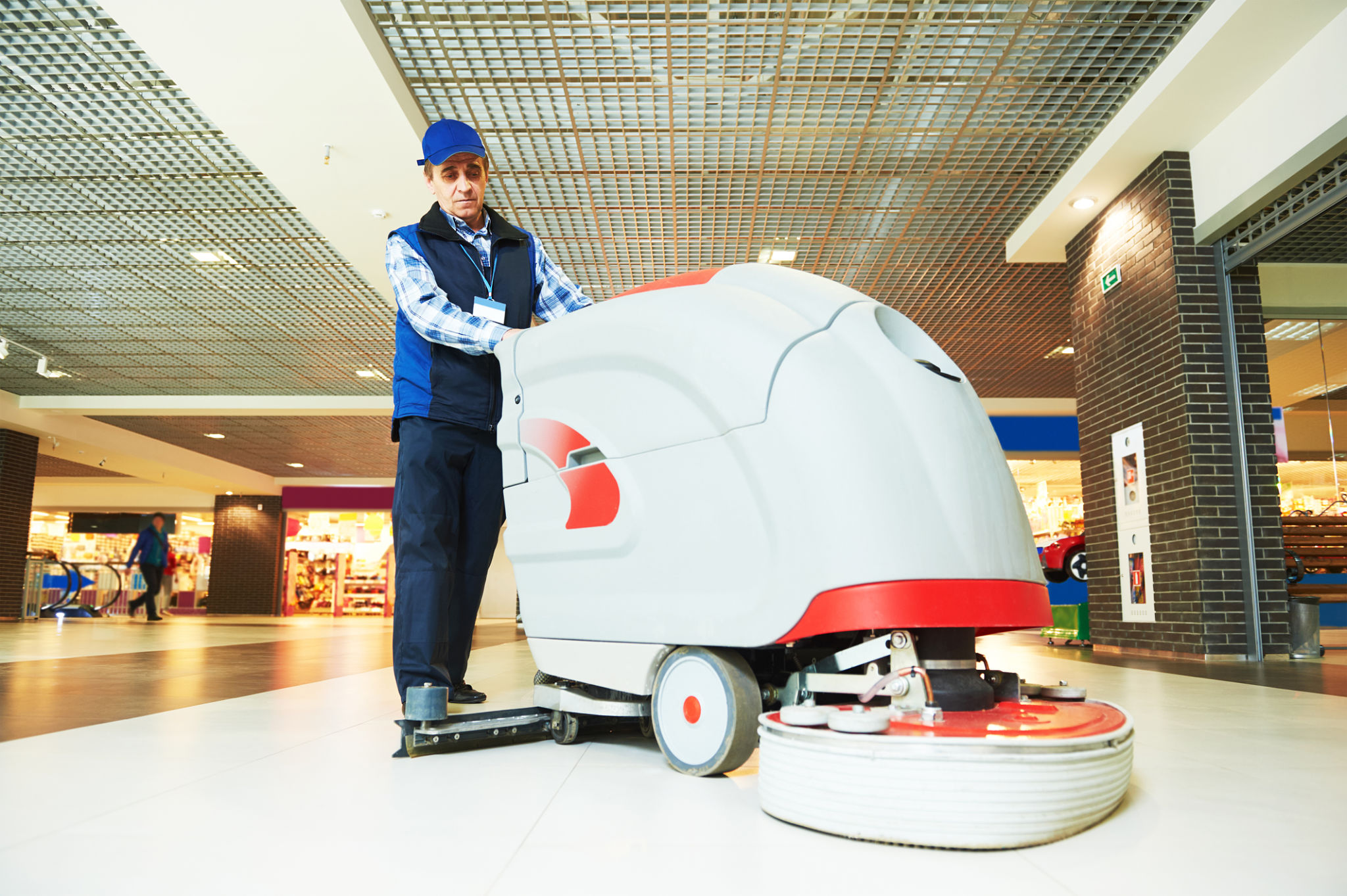 worker cleaning store floor with machine worker cleaning store floor with machine