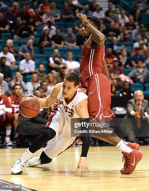 Dwight Powell of the Stanford Cardinal is fouled by Junior Longrus of the Washington State Cougars during a first-round game of the Pac-12 Basketball...