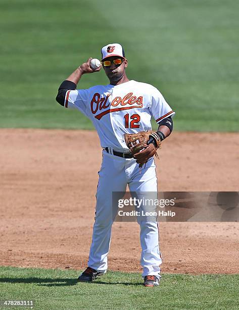 Alexi Casilla of the Baltimore Orioles warms up prior to the start of the third inning of the spring training game against the Boston Red Sox at Ed...