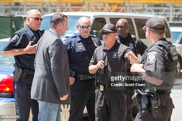 Police officals talk in front of John Joseph Moakley United States Courthouse after a man was taken into custody who had a meat cleaver in his car...