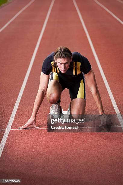 sprinter in starting blocks ready to run - crouch-start stock pictures, royalty-free photos & images