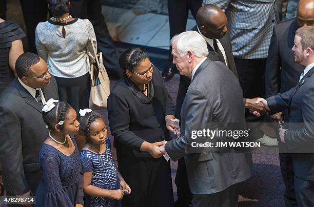 Emanuel AME Church pastor and South Carolina State Sen.Clementa Pinckney's wife Jennifer , and two daughters Eliana and Malana, stand in a receiving...