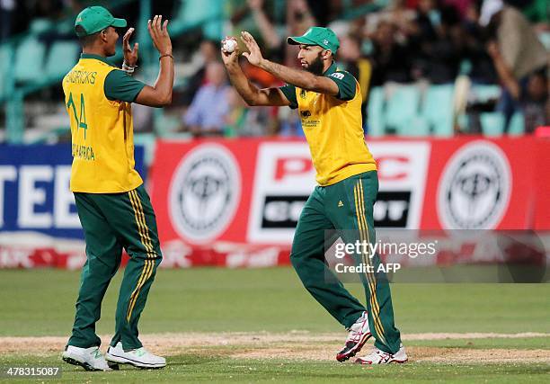 South Africa's Beuran Hendricks and Hashim Amla celebrate Aaron Finch's wicket during the Second KFC T20 International match between South Africa and...