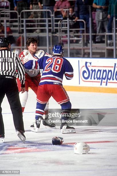 Tie Domi of the New York Rangers fights with Bob Probert of the Detroit Red Wings on February 9, 1992 at the Madison Square Garden in New York, New...