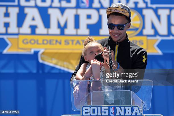 Stephen Curry and of the Golden State Warriors attends the Victory Parade And Rally with his daughter, Riley Curry on June 19, 2015 in Oakland, CA....
