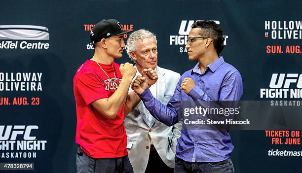 Max Holloway and Charles Oliveira square off in front of join Tom Wright, UFC Executive Vice-President and General Manager for Canada, Australia and...