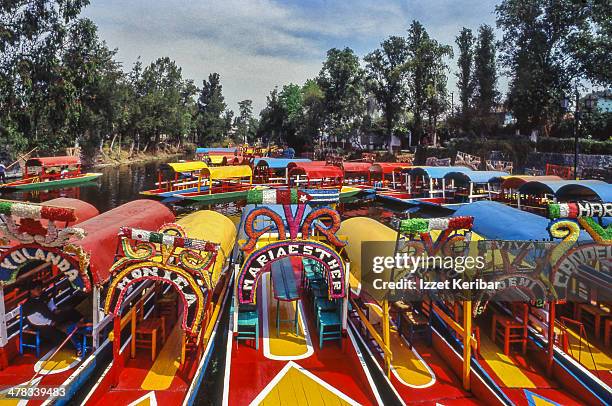 brightly painted trajineras in xochimilco - trajineras stock pictures, royalty-free photos & images