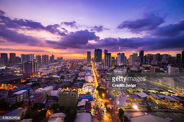 manila city at twilight showing makati city and ortigas - philippines stock pictures, royalty-free photos & images