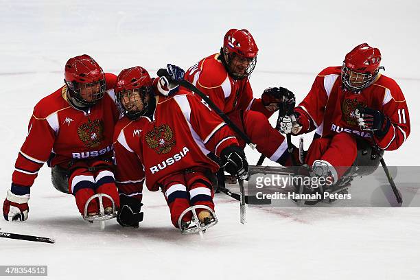 Russia celebrate the goal of Alexey Amosov during the Ice Sledge Hockey semifinal match between Russia and Norway at the Shayba Arena during day six...