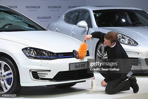 Worker polishes a Volkswagen Golf GTE car prior to the company's annual press conference to announce financial results for 2013 on March 13, 2014 in...