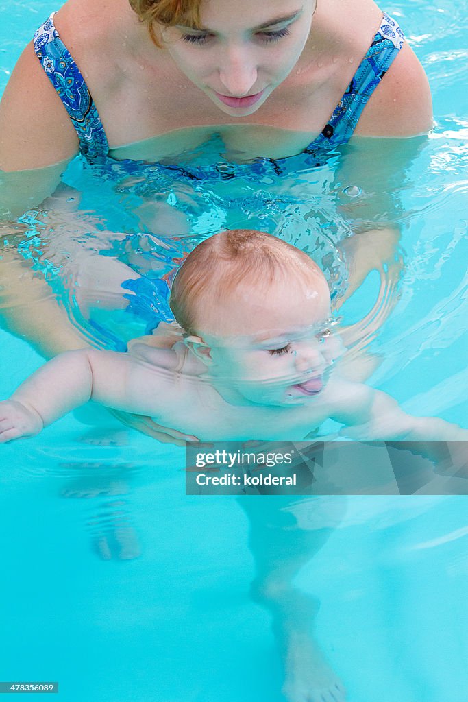 Mother and baby daughter in swimming pool