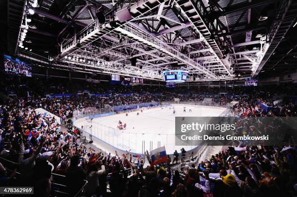 Spectators cheer as russian players celebrate their victory in their Ice Sledge Hockey Play-off semi final against Norway during day six of Sochi...