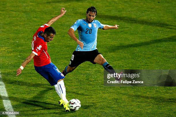 Mauricio Isla of Chile shoots to score the opening goal during the 2015 Copa America Chile quarter final match between Chile and Uruguay at Nacional...