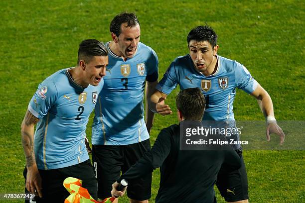 Jose Maria Gimenez, Diego Godin and Jorge Fucile of Uruguay appeal to linesman Emerson De Carvalho during the 2015 Copa America Chile quarter final...