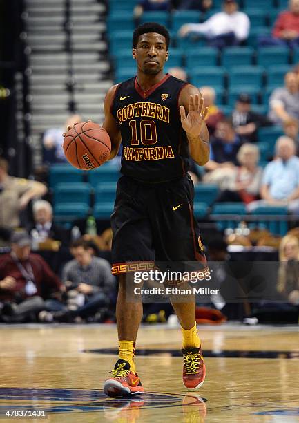 Pe'Shon Howard of the USC Trojans brings the ball up the court against the Colorado Buffaloes during a first-round game of the Pac-12 Basketball...