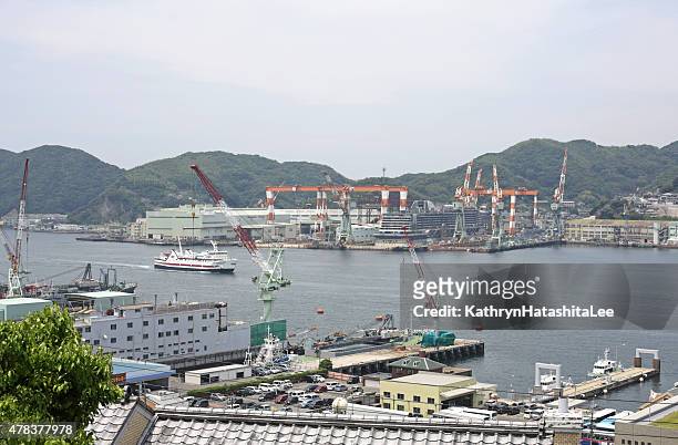 industries on the waterfront of nagasaki bay, japan - nagasaki prefecture stockfoto's en -beelden