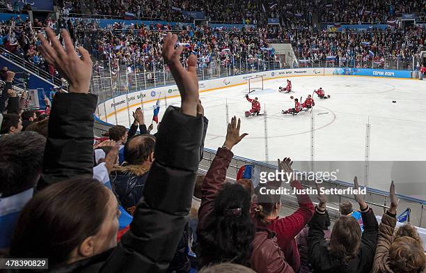 Rusian fans and players celebrate victory after the Ice Sledge Hockey play off semi-final match between Russia and Norway at the Shayba Arena during...