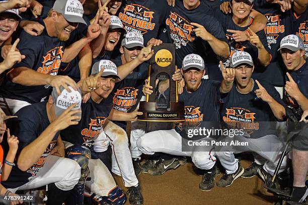 Players of the Virginia Cavaliers hold up the National Championship trophy after defeating the Vanderbilt Commodores during game three of the College...