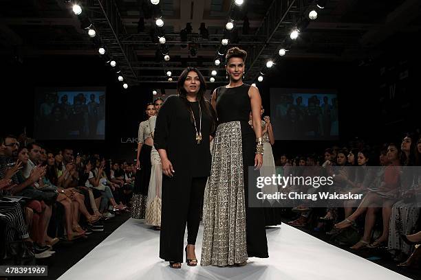 Neha Dhupia walks the runway with Payal Singhal during day 3 of Lakme Fashion Week Summer/Resort 2014 at the Grand Hyatt on March 13, 2014 in Mumbai,...