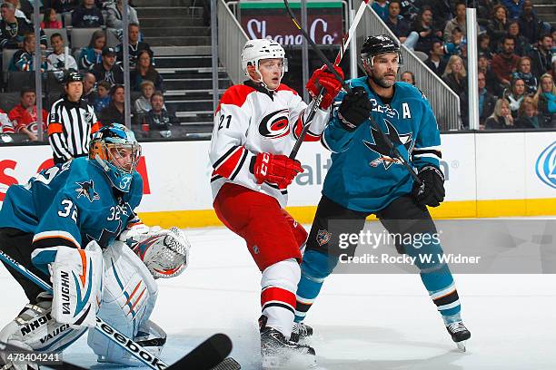 Alex Stalock and Dan Boyle of the San Jose Sharks defend the net against Drayson Bowman of the Carolina Hurricanes at SAP Center on March 4, 2014 in...