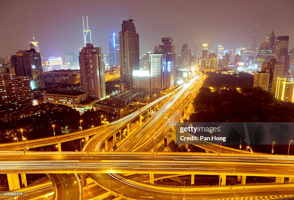 View of busy traffic over overpass at night