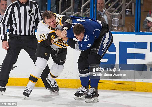 Keith Aulie of the Tampa Bay Lightning fights against Shawn Thornton of the Boston Bruins at the Tampa Bay Times Forum on March 8, 2014 in Tampa,...