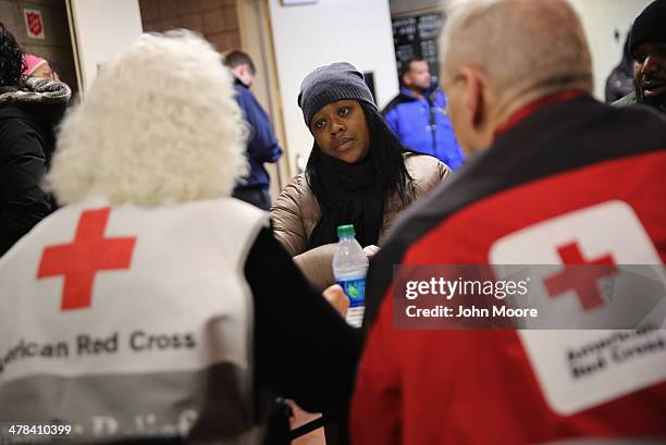 Aisha Watts applies for assistance at an American Red Cross disaster relief center at 125th St. And 3rd Avenue a day after an explosion in East...