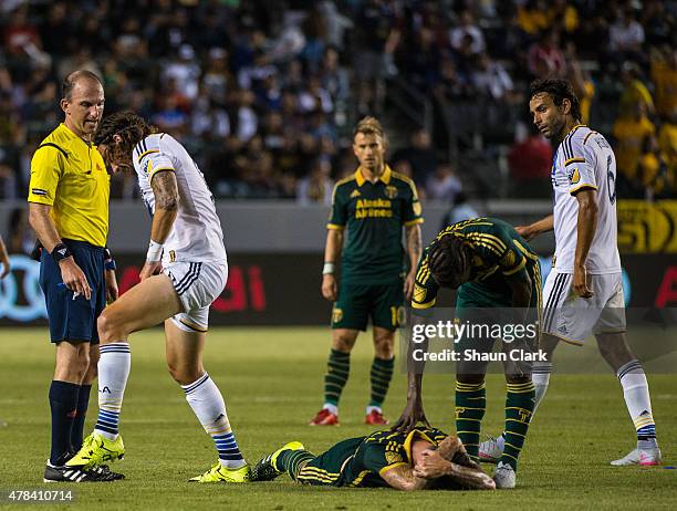 Alan Gordon of Los Angeles Galaxy shows Referee Ted Unkel the damage done by Liam Ridgewell of Portland Timbers lies on the ground during Los Angeles...