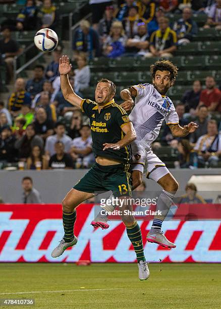 Jack Jewsbury of Portland Timbers and Baggio Husidic of Los Angeles Galaxy jump for a header during Los Angeles Galaxy's MLS match against Portland...