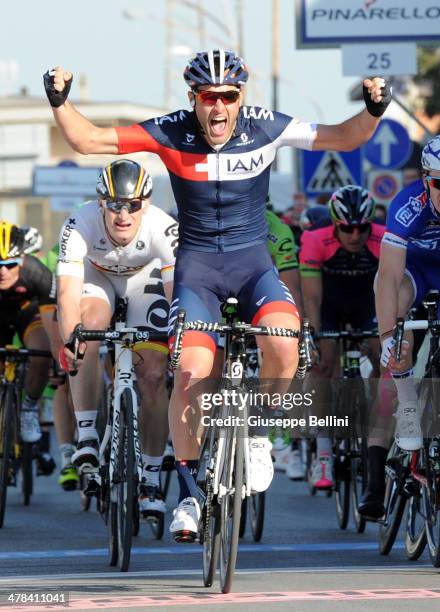 Matteo Pelucchi of IAM Cycling crosses the finish line and wins the stage two of the 2014 Tirreno Adriatico, a 166 km stage from San Vincenzo to...
