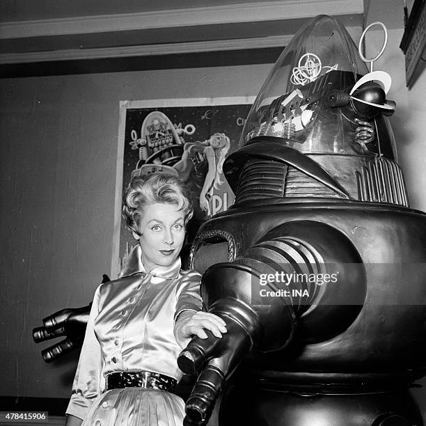 France Roche in the arms of the ""robot"" Robby during the shooting of the program ""Cinepanorama"" .