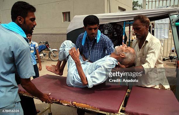 Pakistanis carry a patient who was affected by the heatwave to take her to a hospital in Karachi, Pakistan, on June 25, 2015. More than 1,000 people...