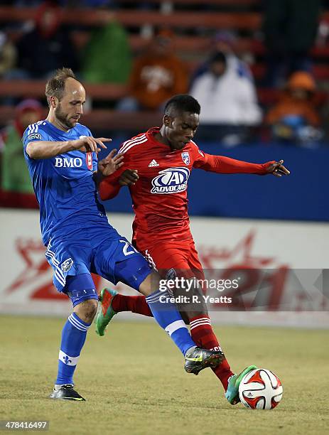 Fabian Castillo of FC Dallas defends the ball from Justin Mapp of Montreal Impact at Toyota Stadium on March 8, 2014 in Frisco, Texas.