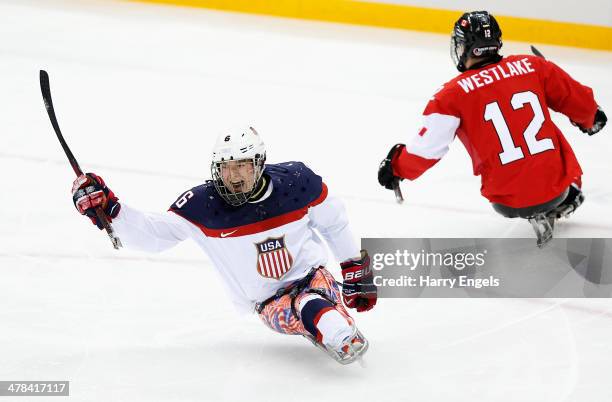 Declan Farmer of USA celebrates scoring his team's first goal during the Ice Sledge Hockey semifinal match between Canada and USA at Shayba Arena...