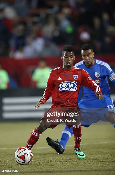 Kellyn Acosta of FC Dallas defends the ball from Matteo Ferrari of Montreal Impact at Toyota Stadium on March 8, 2014 in Frisco, Texas.