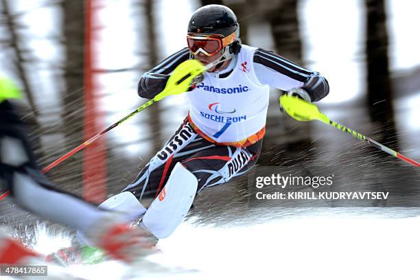 Russia's Valerii Redkozubov competes in the men's Alpine Skiing Slalom Visually Impaired event during the XI Paralympic winter games at the Rosa...