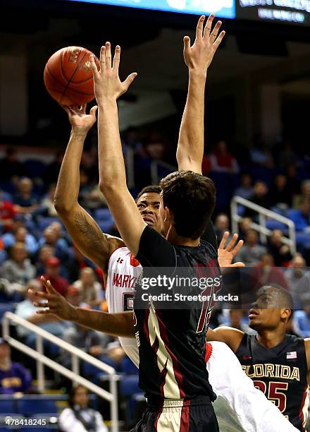 Nick Faust of the Maryland Terrapins drives to the basket against Boris Bojanovsky of the Florida State Seminoles during the second round of the 2014...