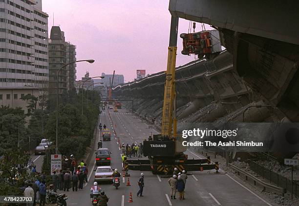 Truck is removed from the collapsed Hanshin Expressway elevated highway on Janaury 18, 1995 in Kobe, Hyogo, Japan. Magnitude 7.3 strong earthquake...