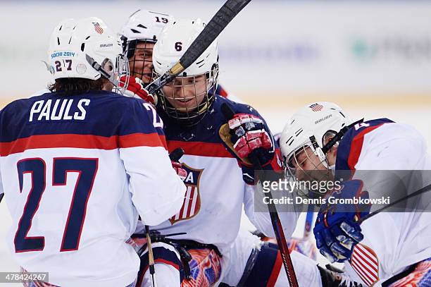 Declan Farmer of the United States celebrates with team mates after scoring his team's second goal during the Ice Sledge Hockey Play-off semi final...