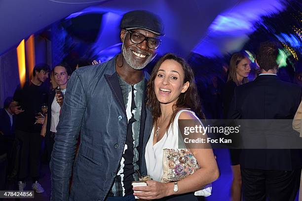 Eriq Ebouaney and Sanaa Alaoui attend the 'Hublot Blue' cocktail party At Monsieur Bleu - Palais De Tokyo on June 24, 2015 in Paris, France.