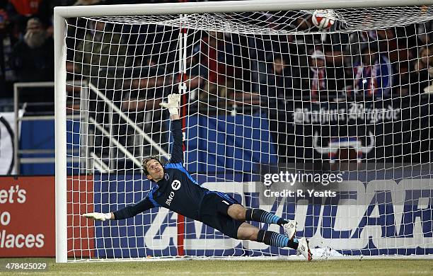 Troy Perkins of Montreal Impact jumps for the save against the FC Dallas at Toyota Stadium on March 8, 2014 in Frisco, Texas.